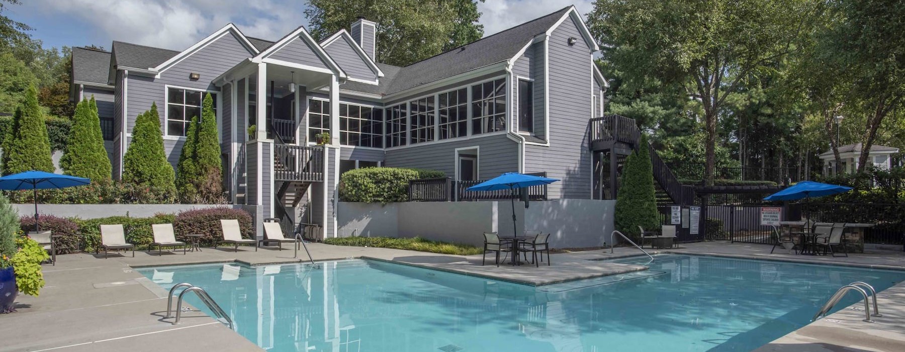 a courtyard with a swimming pool and chairs