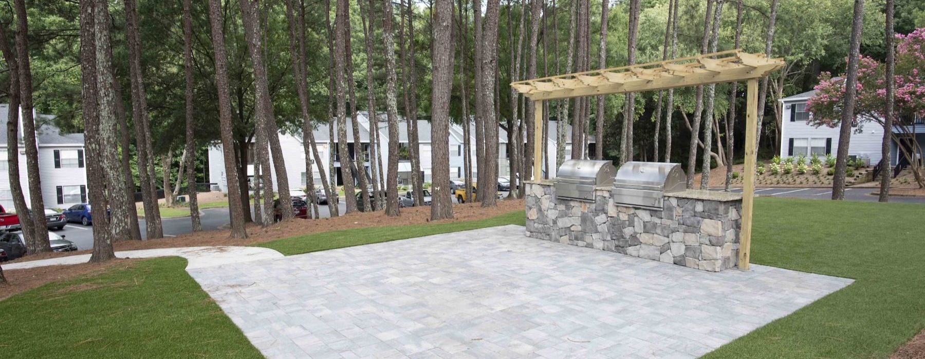 a stone patio with a grill area