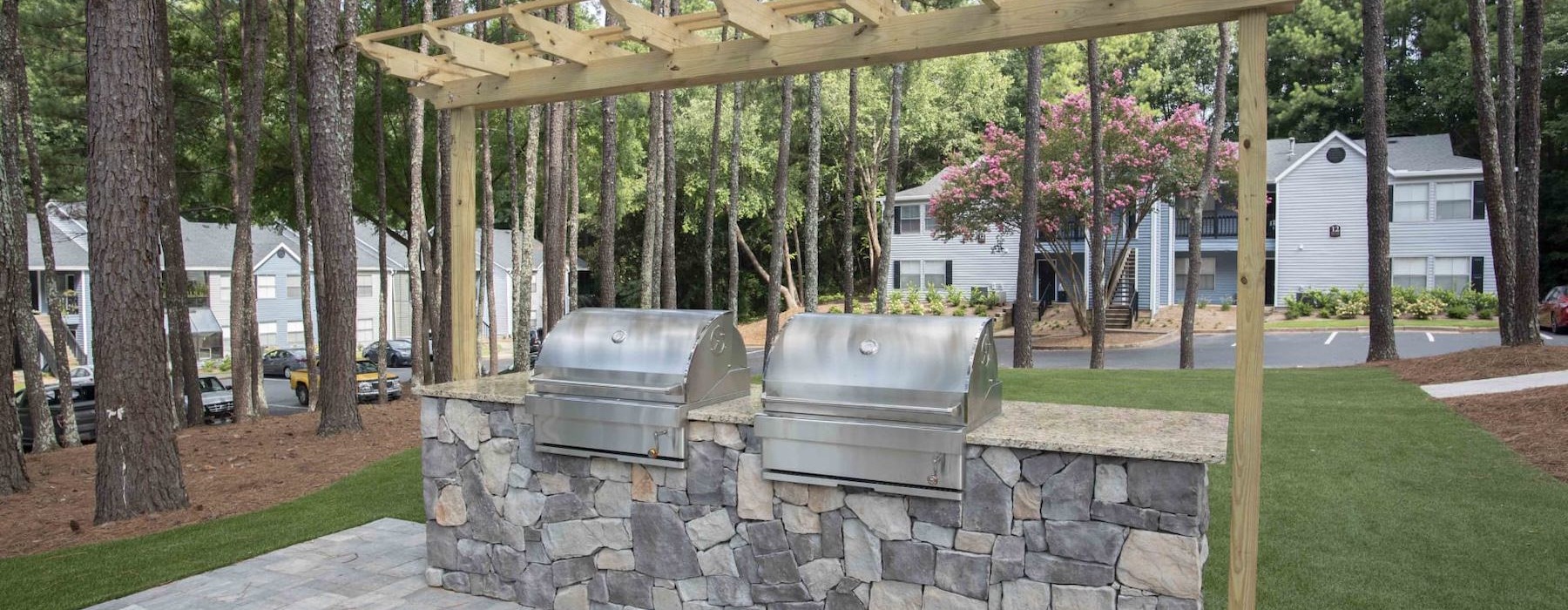 a stone patio with a grill area