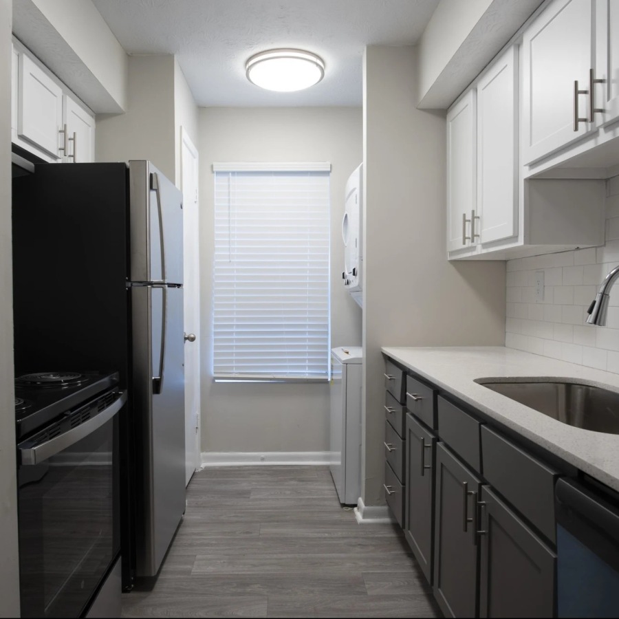 a kitchen with fridge and sink