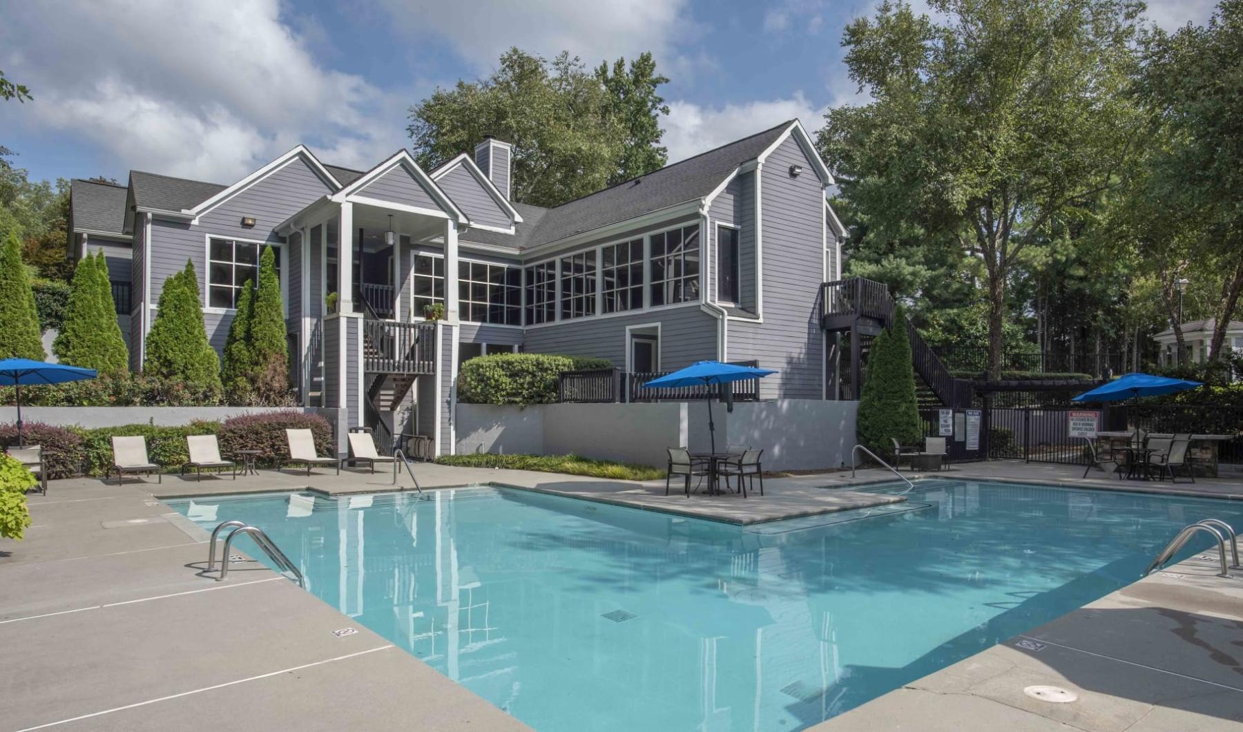 a courtyard with a swimming pool and chairs