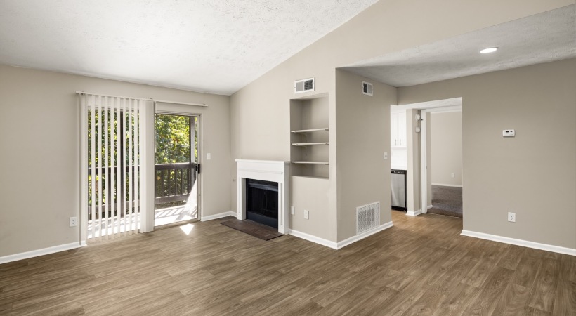 a living room with a fireplace and wood floors